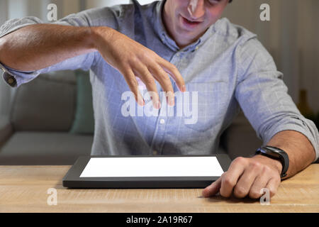 Young man using tablet computer on a table Stock Photo