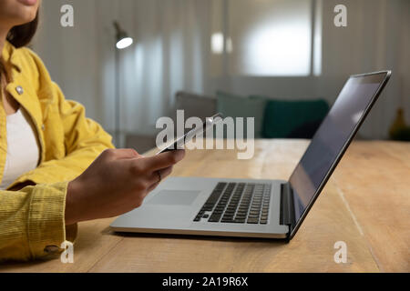 Young woman using laptop computer and smartphone Stock Photo
