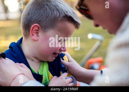 Boy crying and mom trying to calm him down. Children, parents and emotions concept Stock Photo