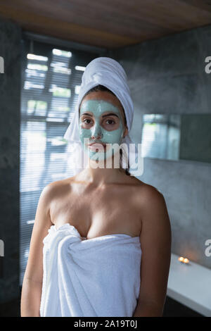 Portrait of young brunette woman with face mask on Stock Photo