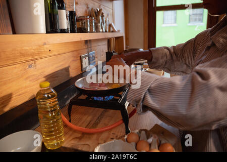 Young woman cooking breakfast at home Stock Photo