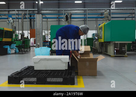 Male factory worker in a factory warehouse building Stock Photo