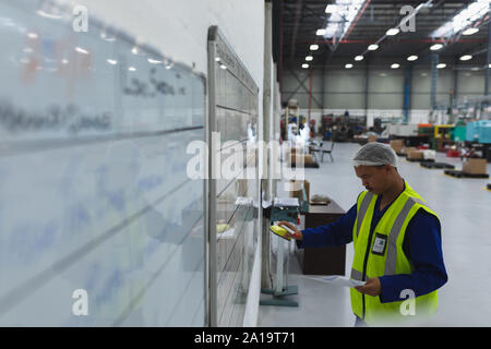 Factory worker in a factory warehouse Stock Photo