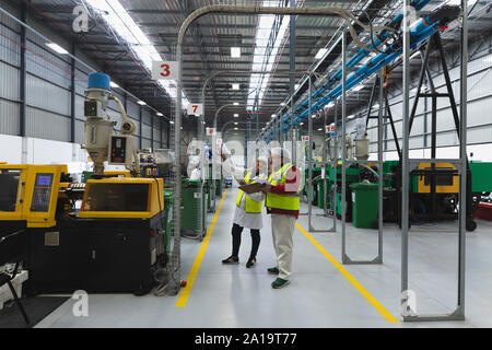 Factory workers in a factory warehouse Stock Photo