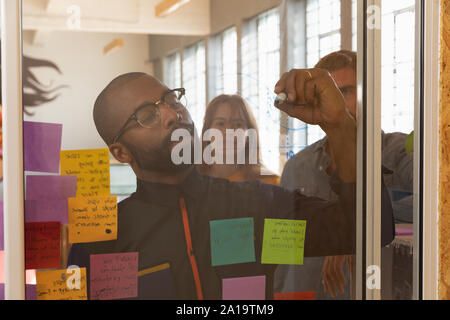 Young creative professional man working in a sunlit office Stock Photo