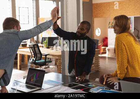 Young creative professionals working in a sunlit office Stock Photo