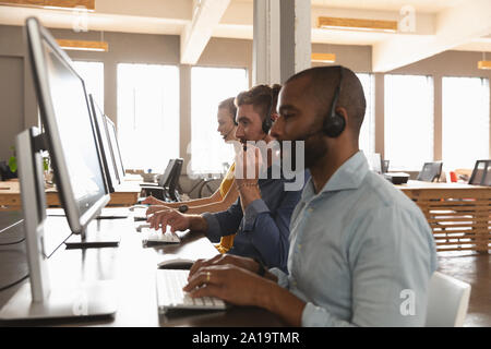 Young creative professionals working in a sunlit office Stock Photo