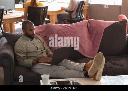 Young creative professional man working in a sunlit office Stock Photo