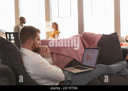 Young creative professionals working in a sunlit office Stock Photo
