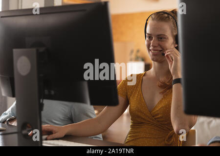 Young creative professional woman working in a sunlit office Stock Photo