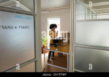 Woman using smartphone in an office Stock Photo