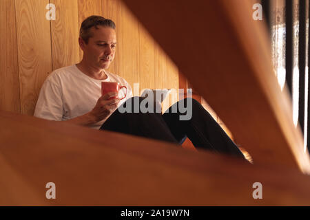 Man using tablet at home Stock Photo