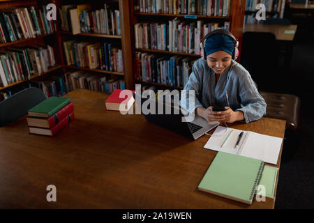 Young woman studying in library Stock Photo