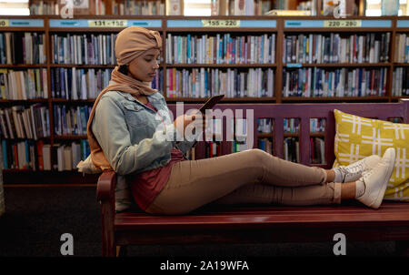 Young woman studying in library Stock Photo