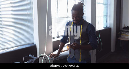 Male student using smartphone at a fashion college Stock Photo