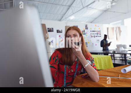 Female student using smartphone at a fashion college Stock Photo