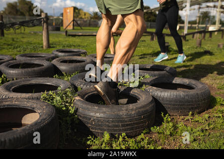 Young man training at an outdoor gym bootcamp Stock Photo