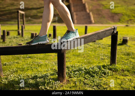Athletic woman is training at an outdoor gym in a fitness park in the ...