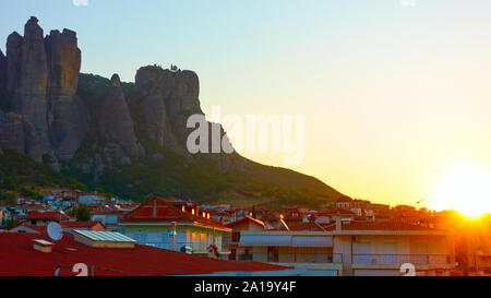 The Meteora rocks and roofs of Kalabaka town at sunrise, Thessaly, Greece - Landscape Stock Photo