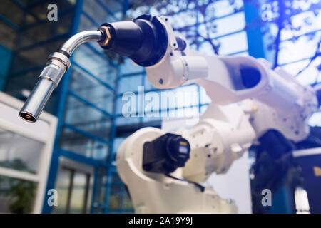 Automatic welding robot in a modern factory in operation. Stock Photo