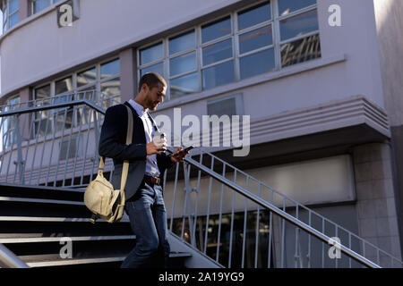 Young professional man using smartphone on the street Stock Photo