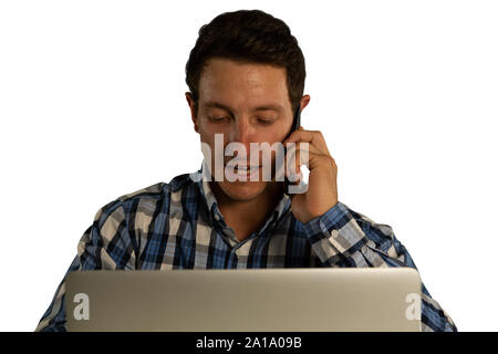 Businessman using a laptop and making a phone call Stock Photo