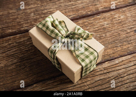 Simple wrapped gift on wooden table Stock Photo