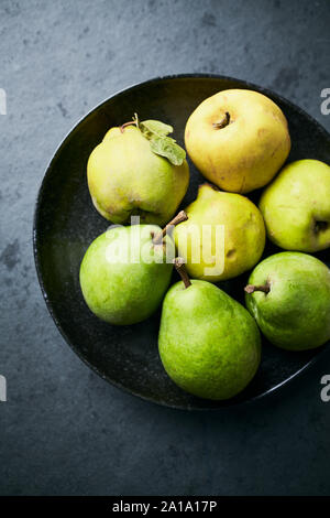 Autumn pears and quinces in a bowl. Still life. Close-up Stock Photo