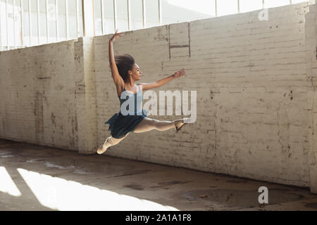 Female dancer in an empty warehouse Stock Photo