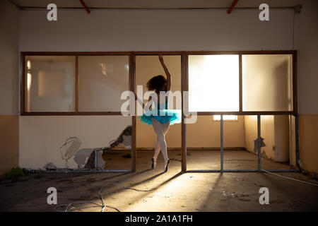 Female dancer in an empty warehouse Stock Photo
