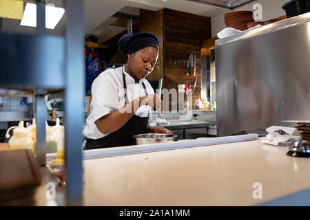 Woman cooking in restaurant kitchen Stock Photo