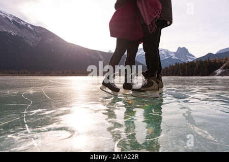 Romantic couple standing in snowy landscape Stock Photo