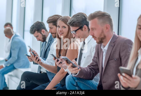 group of diverse young people sitting in the office lobby Stock Photo