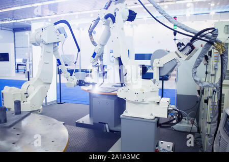 Automatic welding robot in a modern factory in operation. Stock Photo