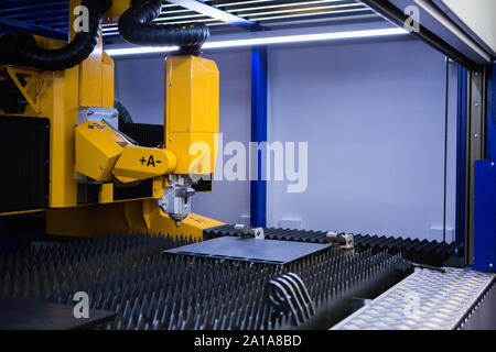 Automatic machine with robotic arm for cutting metal. Smart factory Stock Photo