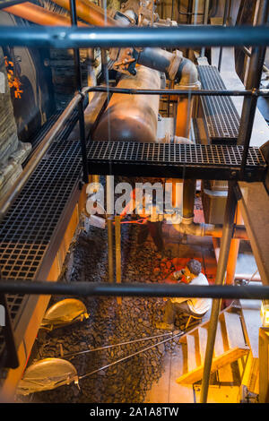 Re-created Engine room and furnace being fed coal by mannequin model figures; engine of the SS Great Britain, Brunel's steam powered ship in dry dock in in Bristol. UK England (109) Stock Photo