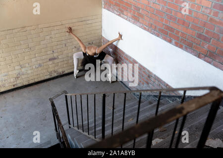 Female dancer in an empty warehouse Stock Photo