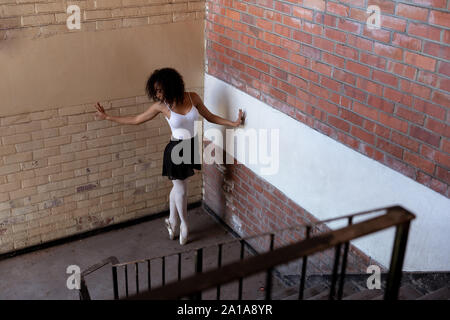 Female dancer in an empty warehouse Stock Photo