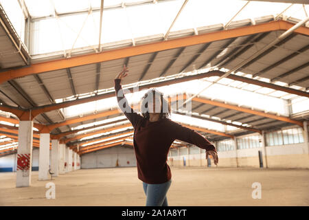 Female dancer in an empty warehouse Stock Photo