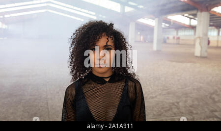 Female dancer in an empty warehouse Stock Photo