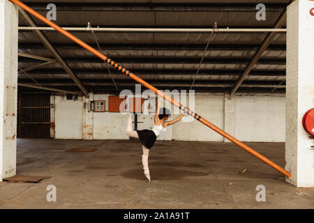 Female dancer in an empty warehouse Stock Photo