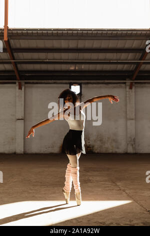 Female dancer in an empty warehouse Stock Photo