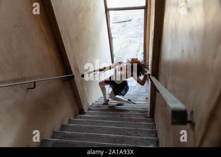 Female dancer in an empty warehouse Stock Photo
