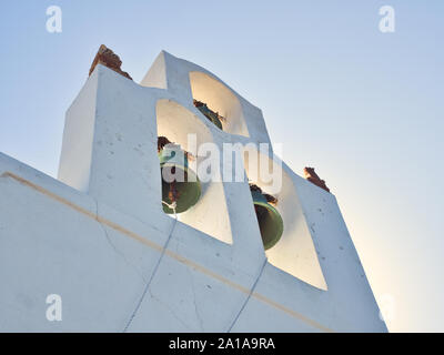 From below bell tower of Nikolaus monastery in Santorini Greece under blue sky on sunny day Stock Photo