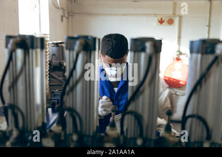 Young man working in a sports equipment factory Stock Photo