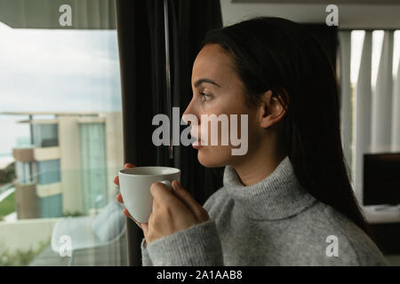 Young brunette woman holding a cup of coffee Stock Photo