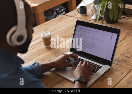 Young creative professional male working in a sunlit office Stock Photo