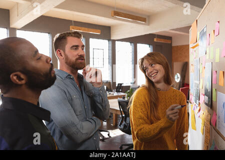 Young creative professionals working in a sunlit office Stock Photo