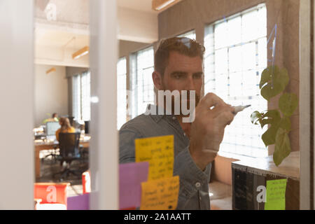 Young creative professional man working in a sunlit office Stock Photo