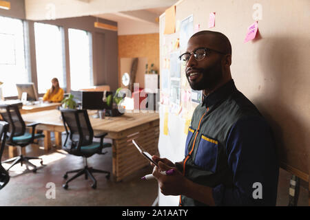 Young creative professional man working in a sunlit office Stock Photo